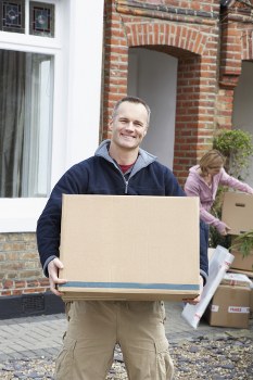 Removals team preparing boxes and furniture with safety equipment