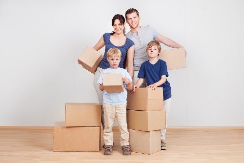 Professional movers handling a flat move in Catford with stairs and careful lifting