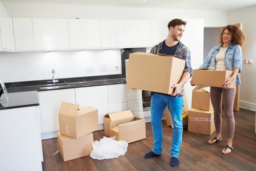 Professional movers handling furniture in a Catford property