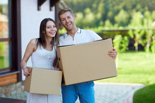 Staff handling furniture and packed items during a removals job