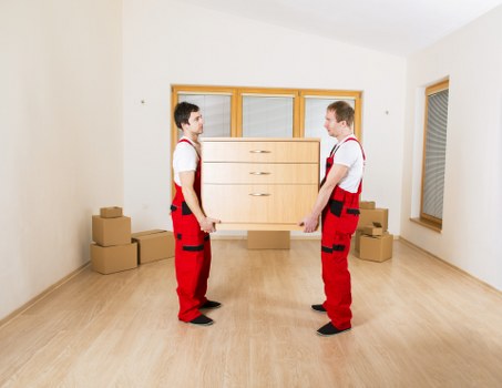 Removal workers using PPE and lifting equipment for safe transport