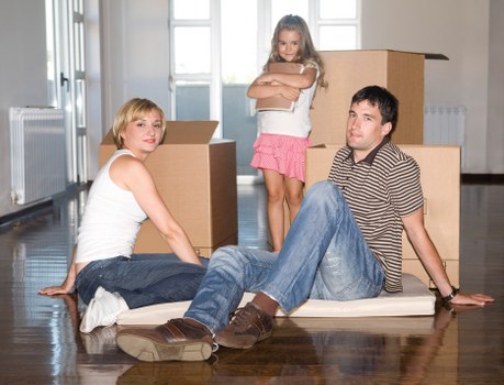 Removal team handling furniture in a Catford property